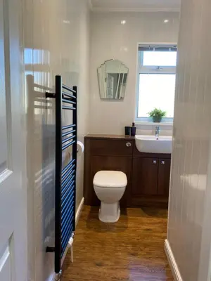 a bathroom with a toilet and a sink at Lynwood Studio in Oban