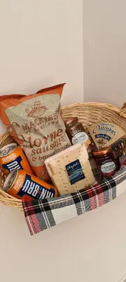 a basket filled with different types of bread and cheese at ALLARDYCE in Kincardine
