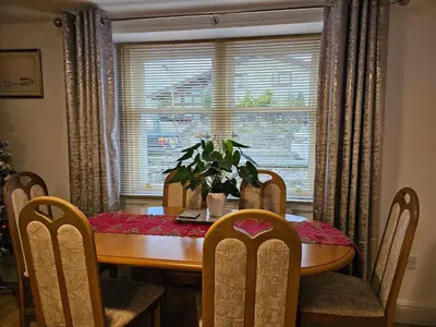a dining room table with a potted plant on it at ALLARDYCE in Kincardine