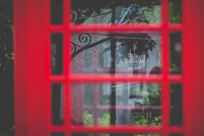 a red phone booth window with a reflection in it at Ardeonaig Hotel & Restaurant in Ardeonaig