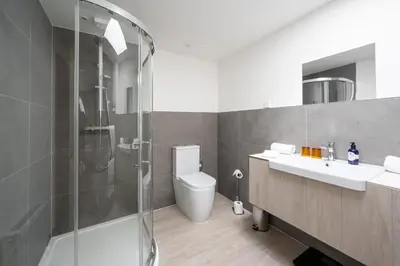 a bathroom with a shower and a sink and a toilet at Ardeonaig Hotel & Restaurant in Ardeonaig