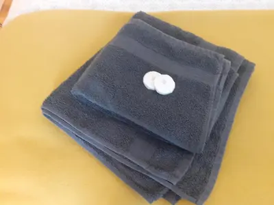a black napkin with a white button on it at THE BOTHY SUITE BY TEMPLE WOOD in Lochgilphead