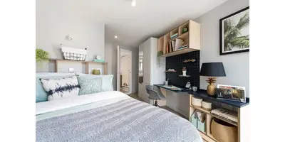 a bedroom with a white bed and a desk at Silk Mill Edinburgh in Edinburgh