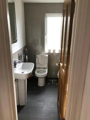 a bathroom with a toilet and a sink and a window at Brecbennoch in Oban