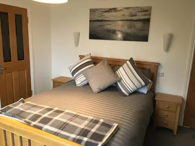 a bed with several pillows on it in a room at Brecbennoch in Oban
