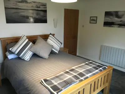 a bedroom with a bed with pillows on it at Brecbennoch in Oban