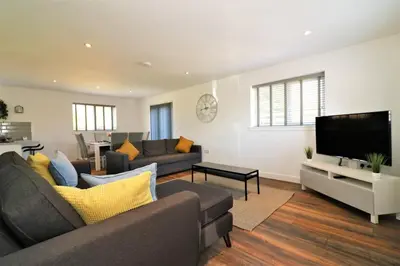 a living room with a couch and a tv at Signature - Railway House 5 bed in Maryhill