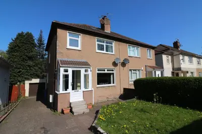 a brown brick house with white windows and a yard at Signature - Dumbreck House in Glasgow