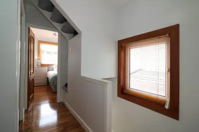 a hallway with a window and a bedroom at Signature - Dumbreck House in Glasgow