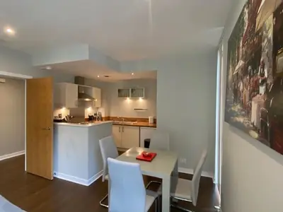 a kitchen with a table and chairs and a table and a counter at Dreamhouse at Oswald Street, City Centre in Glasgow