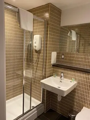 a bathroom with a shower and a sink at Dreamhouse at Oswald Street, City Centre in Glasgow