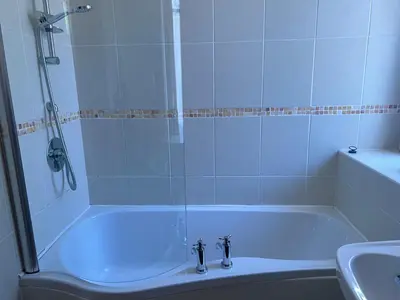 a bathroom with a shower and a tub and a sink at The Maid's House in Lanark