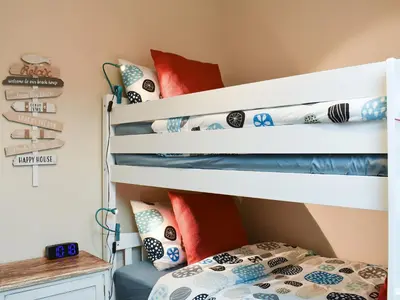 a bunk bed in a bedroom with a bedside table at Ingleside in Whiting Bay