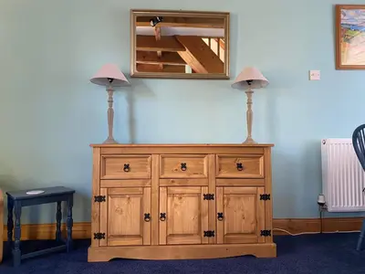 a wooden cabinet with two lamps on top of it at Lamlash- Self catering accommodation with seaviews in Lamlash