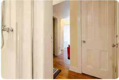 a room with two white doors and a hallway at 3 Bed Central Apartment - Pet Friendly & Parking in Edinburgh