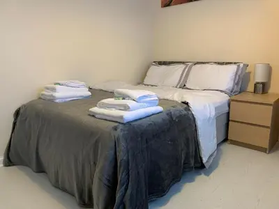 a bed with towels stacked on top of it at Dada House in Glasgow