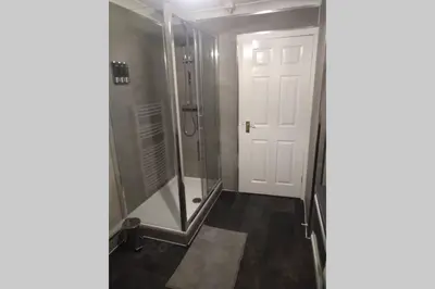 a bathroom with a shower and a glass door at The Cottage - Hot Tub - nr Glasgow - self check-in in Coatbridge