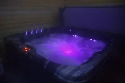 a hot tub with purple lights in a room at The Cottage - Hot Tub - nr Glasgow - self check-in in Coatbridge