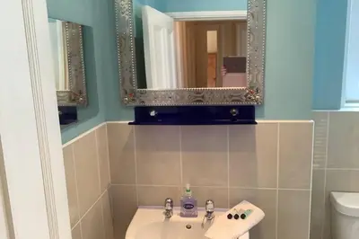 a bathroom with a sink and a mirror at Ferry View in Largs