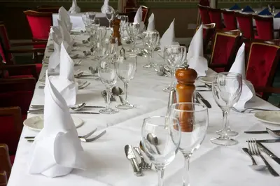 a long table with glasses and napkins on it at North West Castle Hotel in Stranraer