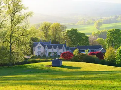 a house on a hill with a green field at The Bothy at Arndean in Dollar