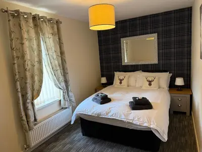 a bedroom with a bed with two towels on it at 3 Dialknowe Holiday Cottage - Wanlockhead - 3 Bedrooms in Wanlockhead