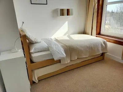 a small bed in a room with a window at Buckieburn - self-catering - rural in Stirling