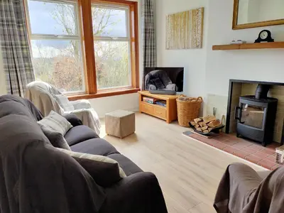 a living room with a couch and a fireplace at Buckieburn - self-catering - rural in Stirling