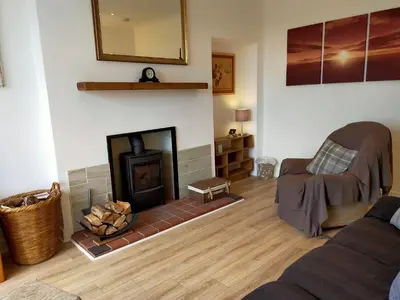 a living room with a fireplace and a couch at Buckieburn - self-catering - rural in Stirling