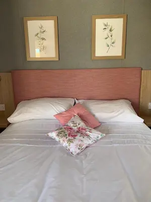a white bed with two pillows on top of it at The Roecliffe 54 in Dunoon