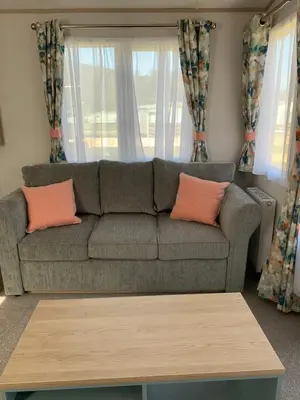 a living room with a couch and a table at The Roecliffe 54 in Dunoon