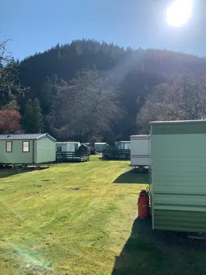 a group of camping huts in a field with a mountain at The Roecliffe 54 in Dunoon