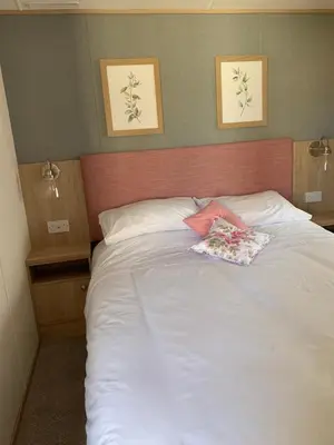 a large white bed with two pillows on it at The Roecliffe 54 in Dunoon