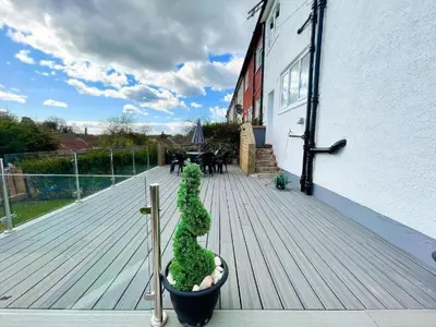 a wooden deck with aotted plant on a building at Beautifully Designed Pollok House in Glasgow