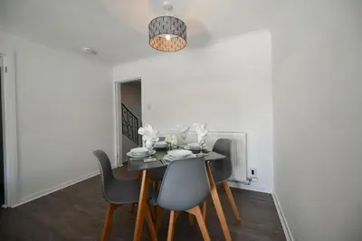 a dining room with a black table and chairs at Mews House in Ayr