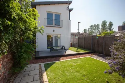 a backyard with a bench and a fence at Southside Flat with Private Garden! in Glasgow
