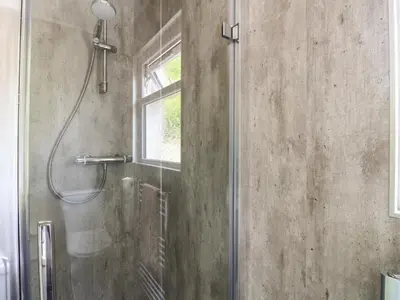 a shower in a bathroom with a glass shower backdoor at Innishail in Lochgilphead