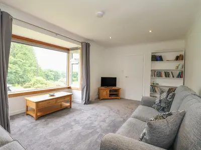a living room with a couch and a tv at Innishail in Lochgilphead