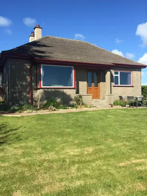 a house with a lawn in front of it at Erradill Cottage in Southend