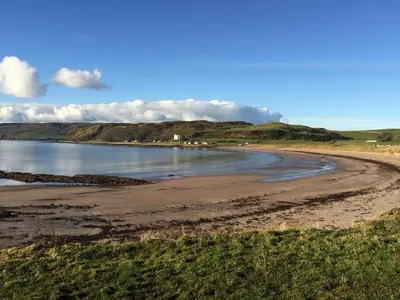 a beach in the middle of a body of water at Erradill Cottage in Southend