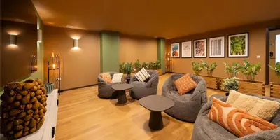 a lobby with couches and tables in a room at Canvas Glasgow in Glasgow