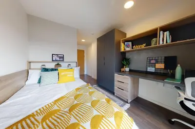 a bedroom with a large bed and a desk at Canvas Glasgow in Glasgow