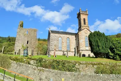an old stone church with a clock tower on a hill at Nursery Cottage in Kilmun