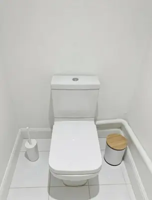 a white bathroom with a toilet in a room at Dreghorn House 5 b-rooms 9 beds 3 toilets 2 showers,1 bath 2 receiption Secure free Parking 233 Wifi in Edinburgh
