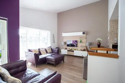 a living room with a couch and a tv at Mosspark Boulevard Exec Apartment ii - Free Parking in Glasgow