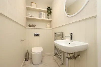 a bathroom with a sink and a mirror and a toilet at Argyl - Central Old Town Mews Home with Parking in Edinburgh