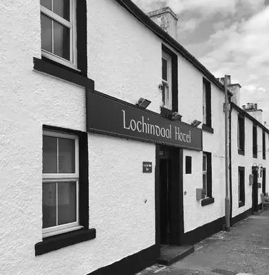 a black and white photo of a building at Lochindaal Hotel in Port Charlotte