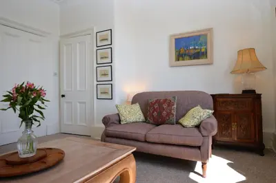 a living room with a couch and a table at Kimberley Apartment in Dunoon
