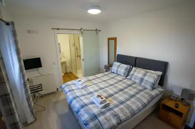 a bedroom with a bed with a dog on it at Corran Bunkhouse in Onich