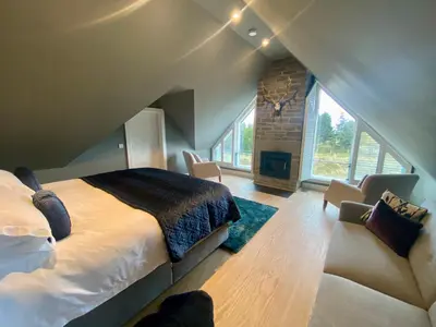 a bedroom with a bed and a fireplace in a room at The Lodge at Muir Estate in Thornhill